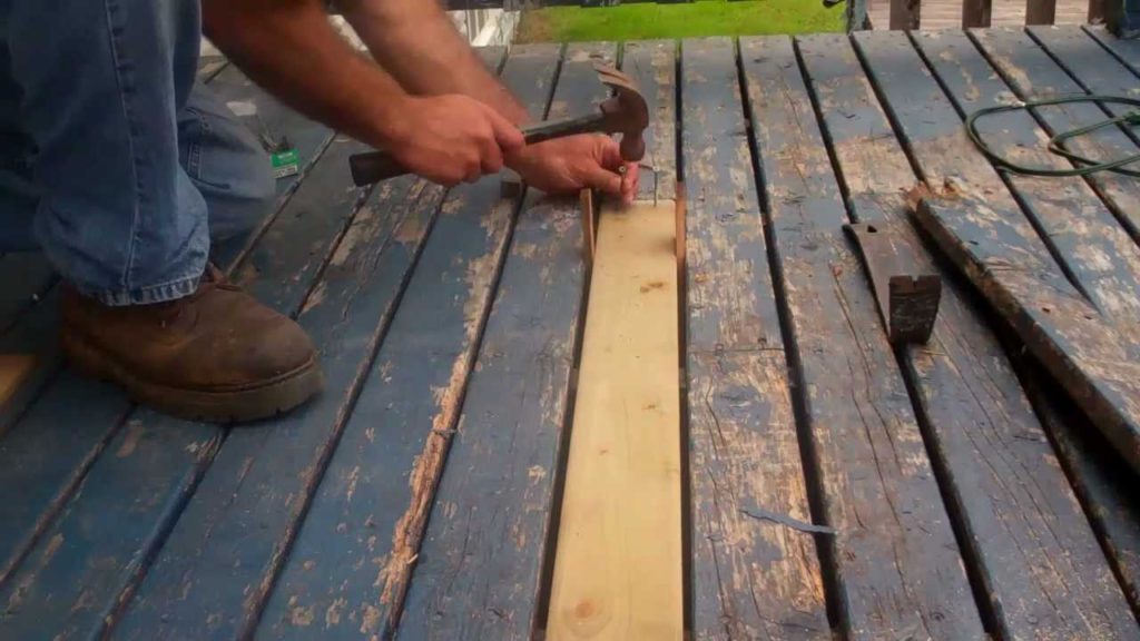 man repairing deck