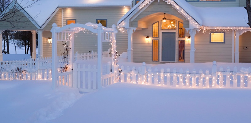 fence decorated with lights